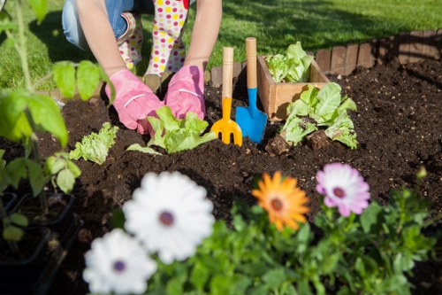 Gardeners wearing gloves preparing materials for composting